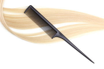 Shiny blond hair and comb isolated on white