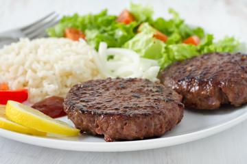 grilled hamburger with rice and salad