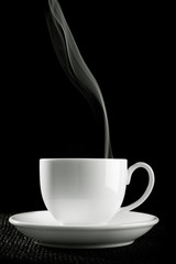 coffee cup over the table against black background