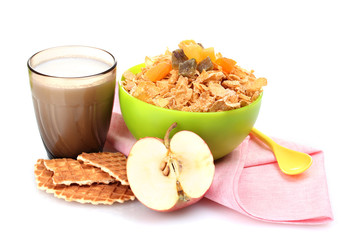 tasty cornflakes in green bowl and glass of milk isolated