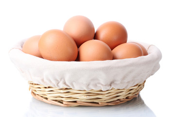 brown eggs in basket isolated on white