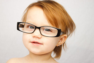 Adorable little girl with large glasses