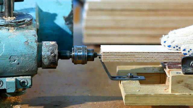 Drilling a plywood from side at wood factory
