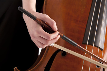 closeup on hand with bow playing the double bass