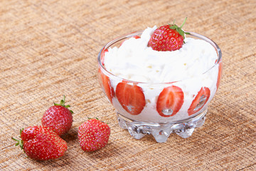 Vase of strawberries with cream