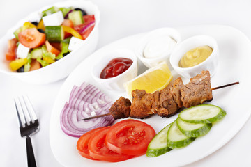 Kebab with fresh vegetables and greek salad