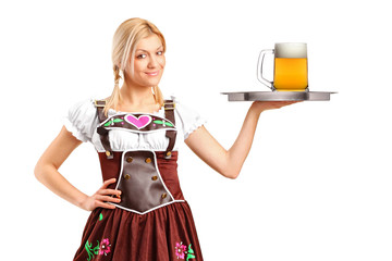 Woman in traditional costume holding a tray with beer glass