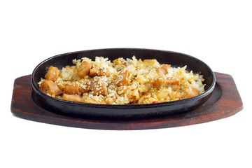 Rice and meat fried in a frying pan