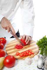 Cook hand with knife cutting vegetable