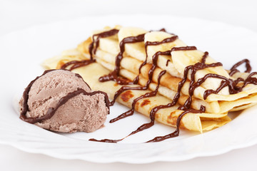 Thin pancakes with banana, ice cream and chocolate