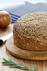 Bread with a sesame on a wooden stand