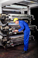 professional printer operating industrial printing machine