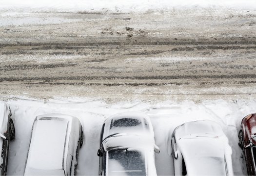 parking lot with cars covered in snow detail view from above