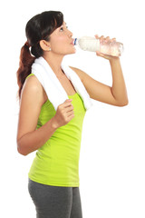 fitness woman drinking water isolated over white background