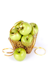 Green apples in a gold basket
