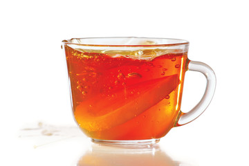 Cup of ice tea and lemon with splash on a white background