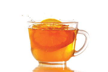 Cup of ice tea and lemon with splash on a white background