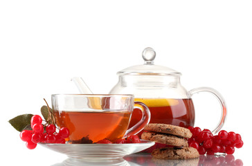Glass teapot and cup with black viburnum hips tea isolated