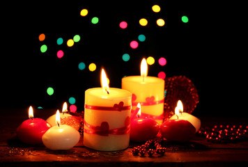 Beautiful candles on wooden table on bright background