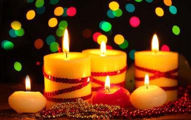 Beautiful candles and decor on wooden table on bright background