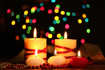 Beautiful candles and decor on wooden table on bright background