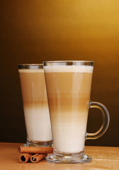 Fragrant сoffee latte in glass cup and cinnamon