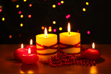 Beautiful candles and decor on wooden table on bright background