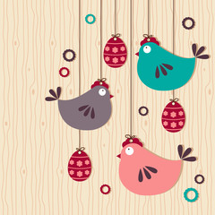 hanging easter chickens on wooden background