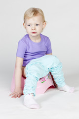 little girl using potty