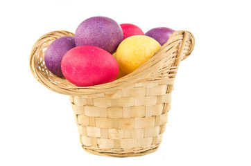 Easter basket with colored eggs iaolted on white