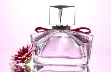 women's perfume in beautiful bottle and flower isolated on white