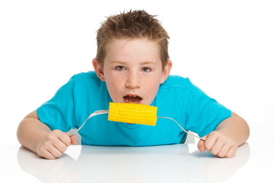 Boy eating corn on cob
