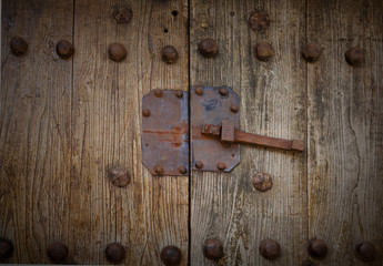 rusty lock on wooden door