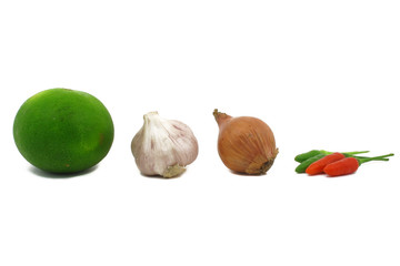 Lime, garlic, shallot, and chilli peppers on white background