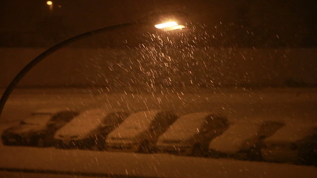 Cars under the snow at night