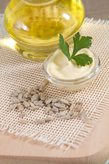 Sunflower oil, mayonnaise and seeds on sacking