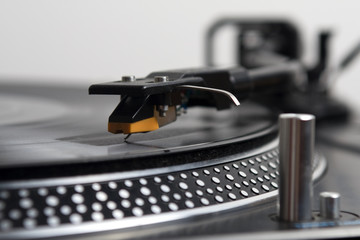 Record spinning on a turntable - focus on the needle