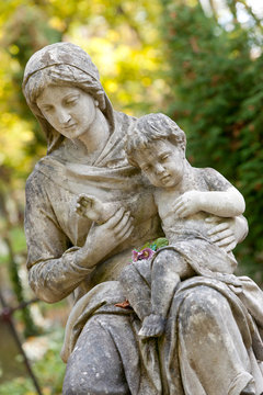 Monument of the woman with the child on a cemetery