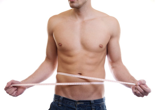 Muscular man measuing waist