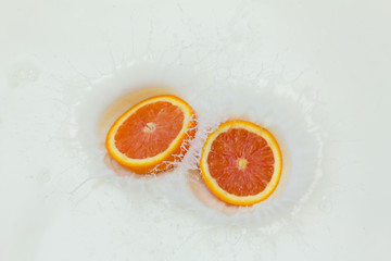 Orange and splashing milk