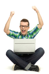 Guy using laptop with arms raised