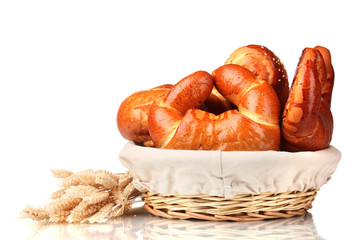 Baked bread in basket isolated on white
