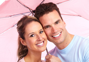 Happy couple in love under umbrella.