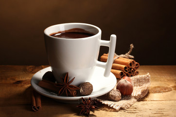 cup of hot chocolate, cinnamon sticks, nuts and chocolate