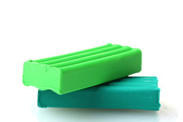 Children bright green plasticine isolated on white