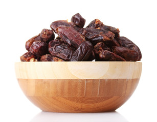 delicious dried dates in wooden bowl isolated on white