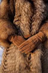 Wearing fur coat and gloves in cold winter