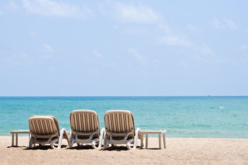 Fototapeta na wymiar White sand beach beach chairs.