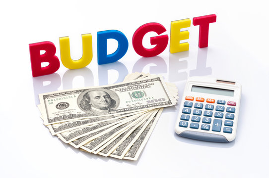 Budget words, American banknotes and calculator