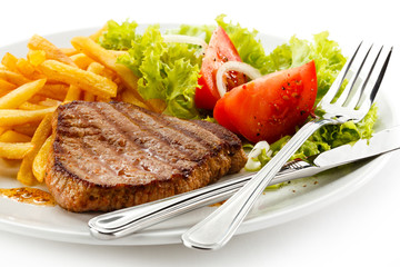 Grilled steak, French fries and vegetables